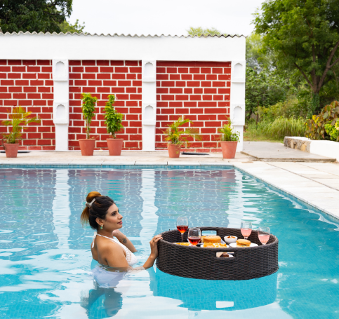 Swimming pool surrounded by countryside greenery