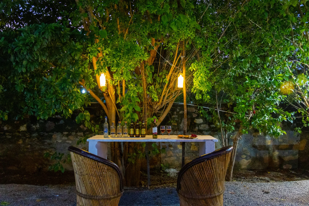 Poolside party setup — string lights, seating, lake or hill view in background